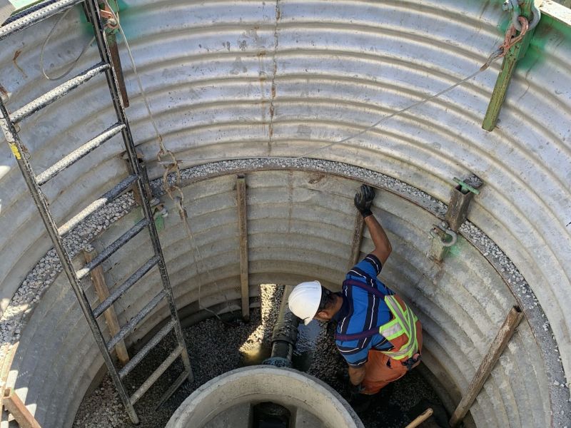 City worker installing a sanitary manhole